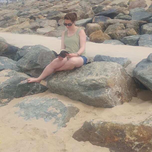 Leona reading on beach in Nantes